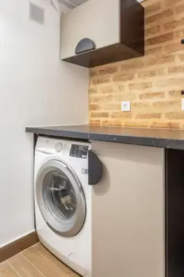 a washing machine in a kitchen with a counter top at Blife Galya private rooms in Faro