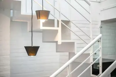 a staircase with three lights hanging from the ceiling at Blife Galya private rooms in Faro