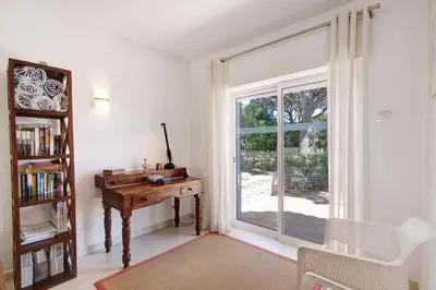 a room with a desk and a large window at Townhouse Ramas in Vale do Lobo