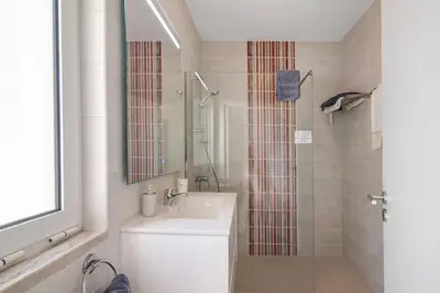 a bathroom with a toilet and a sink and a shower at Townhouse Ramas in Vale do Lobo