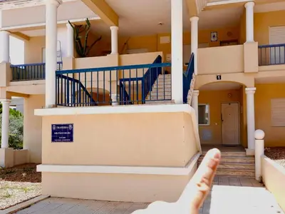 a hand is pointing at a house with stairs at Blife Macaya private rooms in Monte Negro