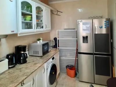 a kitchen with a refrigerator and a washing machine at Blife Macaya private rooms in Monte Negro