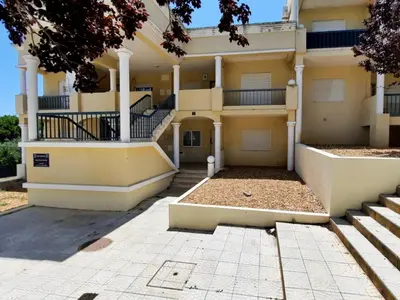 a large yellow building with stairs in front of it at Blife Macaya private rooms in Monte Negro