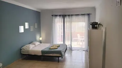 a bedroom with a bed and a large window at Blife Macaya private rooms in Monte Negro