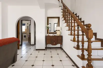 a hallway with a staircase and a mirror at Vila Branca - V3 by HD PROPERTIES in Quarteira