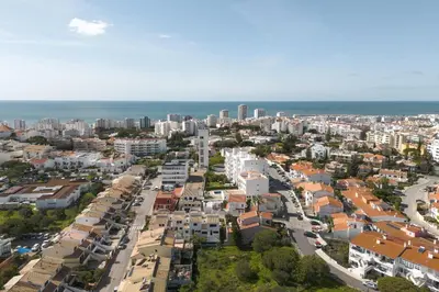 an aerial view of a city with buildings and the ocean at Vila Branca - V3 by HD PROPERTIES in Quarteira
