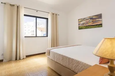 a bedroom with a bed and a window at Vila Branca - V3 by HD PROPERTIES in Quarteira