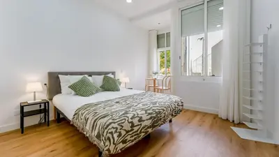 a bedroom with a bed and a window and a table at Modern Retreat 1 in Faro by Lovelystay in Faro