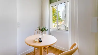 a small table and chairs in a room with a window at Modern Retreat 1 in Faro by Lovelystay in Faro