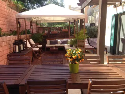 a patio with a couch and an umbrella at Casa Estelliane in Paderne