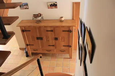 a kitchen with wooden cabinets and a stove top oven at Casa Estelliane in Paderne