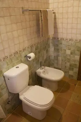 a bathroom with a sink and a tub and a mirror at Casa Estelliane in Paderne