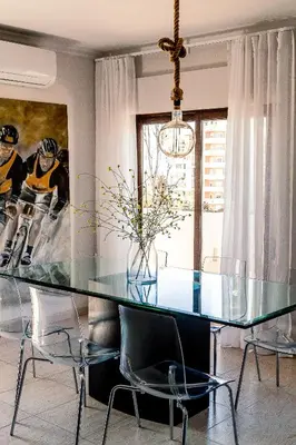 a dining room with a glass table and chairs at Casa Gulbenkian - Modern apartment by HD in Faro