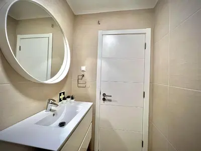 a white bathroom with a sink and a mirror at Vilamoura Eden Villa With Pool by Homing in Vilamoura