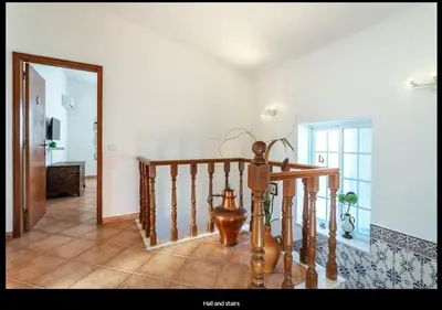 a room with a staircase and aoyer with a mirror at Blife Moustachya private rooms in Faro