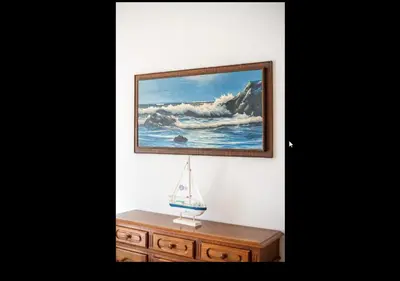 a painting of a sailboat on a wooden dresser at Blife Moustachya private rooms in Faro