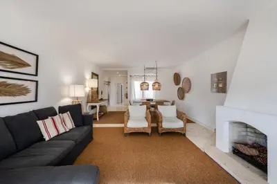 a living room with a couch and a fireplace at Vilamouratenis Wave by SAPvillas in Vilamoura