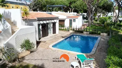 a swimming pool in the backyard of a house at #214 Vivenda 3 Quartos by Home Holidays in Albufeira