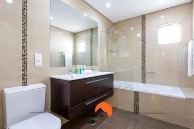 a bathroom with a toilet and a sink and a shower at #214 Vivenda 3 Quartos by Home Holidays in Albufeira