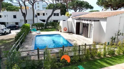 a swimming pool in a yard next to a house at #214 Vivenda 3 Quartos by Home Holidays in Albufeira