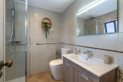 a bathroom with a toilet and a sink and a shower at Albufeira Balaia Golf Vilage 5 With Pool by Homing in Albufeira