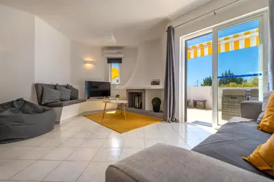 a living room with a couch and a tv at Albufeira Balaia Golf Vilage 6 With Pool by Homing in Albufeira