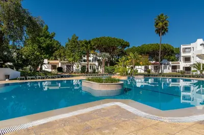 a large swimming pool with trees and buildings at Albufeira Balaia Golf Vilage 6 With Pool by Homing in Albufeira