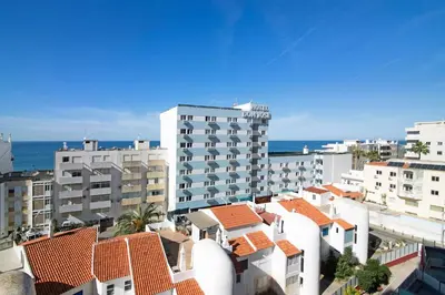 a view of a city with buildings and the ocean at Apartamento Sunny in Quarteira
