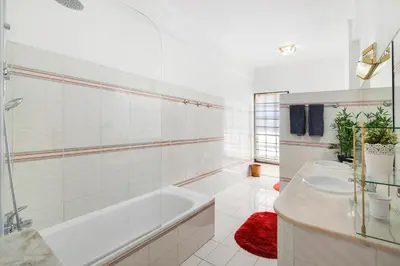 a bedroom with a bed and a desk and a window at Sunshine House in Faro
