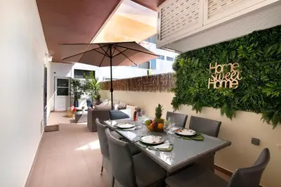 a white bedroom with a bed and a tv at Luxury Home Sweet Home T3 in Faro