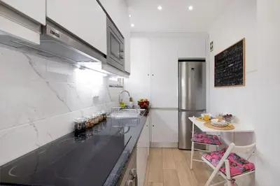 a kitchen with a black counter top and a refrigerator at Luxury Home Sweet Home T3 in Faro