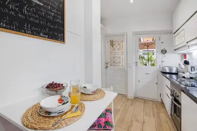 a kitchen with a table with a chalkboard on the wall at Luxury Home Sweet Home T3 in Faro