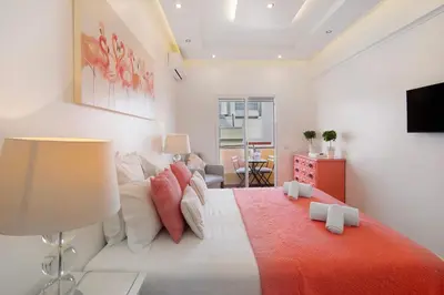 a bedroom with a large bed with a red blanket at Luxury Home Sweet Home T3 in Faro