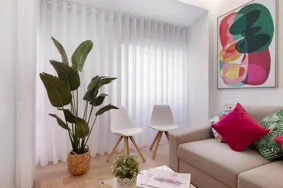 a mirror on a wall in a room with a table at Luxury Sweet Homes T2 in Faro