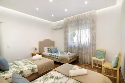 a room with three beds and a window at Country House Casa Da Avó in Loulé