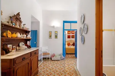 a room with a wooden cabinet and a blue doorway at Country House Quinta da Ilda in Loulé