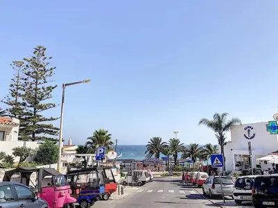 a street with cars parked on the side of a beach at RoofTOP Everest : vue mer panoramique amazing in Albufeira