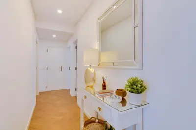 a white dressing table in a hallway with a mirror at Downtown Bingo Apartment in Faro