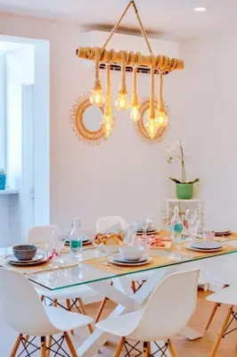 a dining room table with white chairs and a chandelier at Downtown Bingo Apartment in Faro