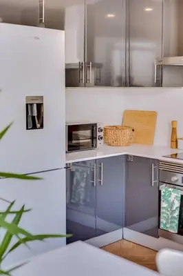 a kitchen with stainless steel appliances and a counter at Downtown Bingo Apartment in Faro