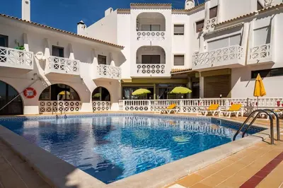 a swimming pool in front of a building at Double ROOFTop Mont-Blanc : vue plage amazing in Albufeira