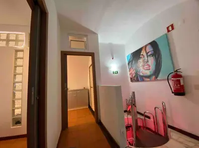 a hallway with a painting of a woman on the wall at Double ROOFTop Mont-Blanc : vue plage amazing in Albufeira