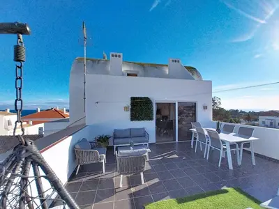 a patio with chairs and a table on a roof at Double ROOFTop Mont-Blanc : vue plage amazing in Albufeira
