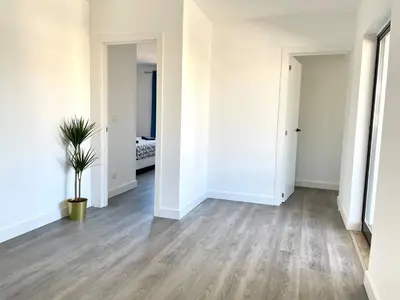 an empty room with white walls and a potted plant at V8 Praia da Falésia, Albufeira in Olhos de Água