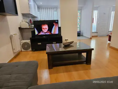 a living room with a tv and a coffee table at Blife Joanya private apartment in Faro
