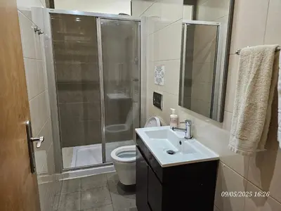 a bathroom with a shower and a sink and a toilet at Blife Joanya private apartment in Faro
