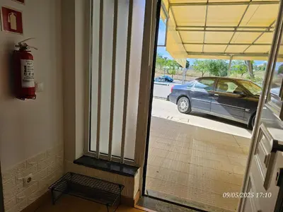 a door to a hallway with a car on a street at Blife Joanya private apartment in Faro