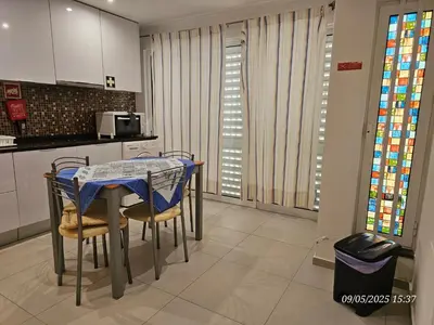 a kitchen with a table and chairs in a room at Blife Joanya private apartment in Faro