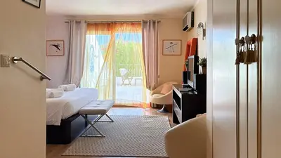 a bedroom with a bed and a sliding glass door at Vista Marina Exclusiva T1 HsR Vilamarina in Quarteira