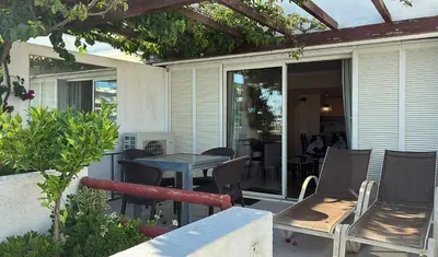 a patio with a table and chairs and a table at Vista Marina Exclusiva T1 HsR Vilamarina in Quarteira